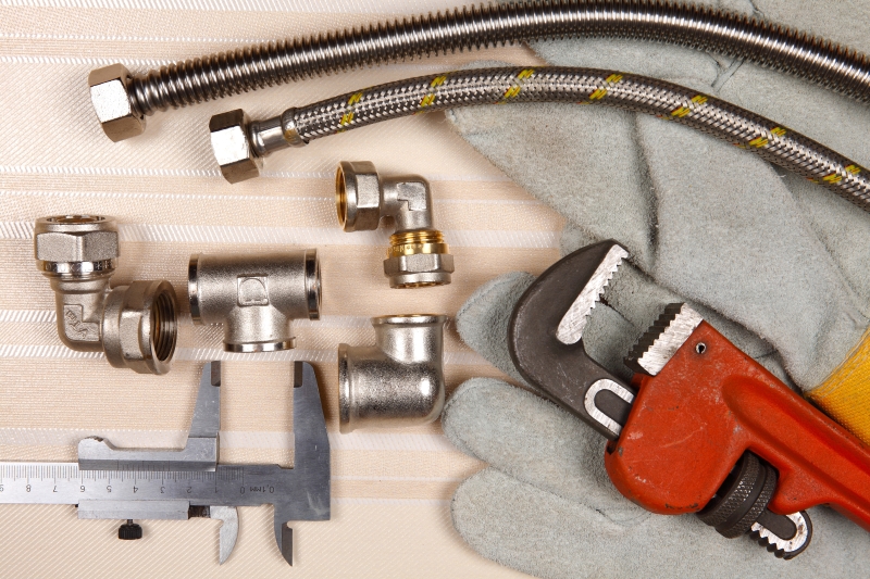 Plumber working on pipes in a Paddington home